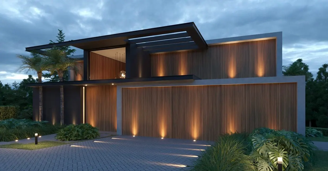 Fachada iluminada da Residência M+C à noite